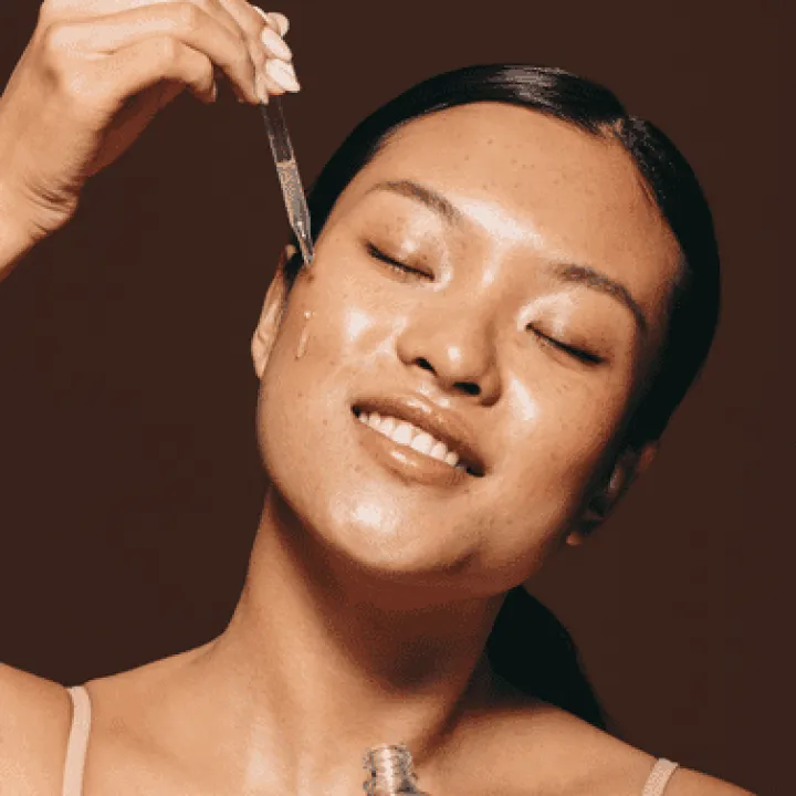 women applying serum